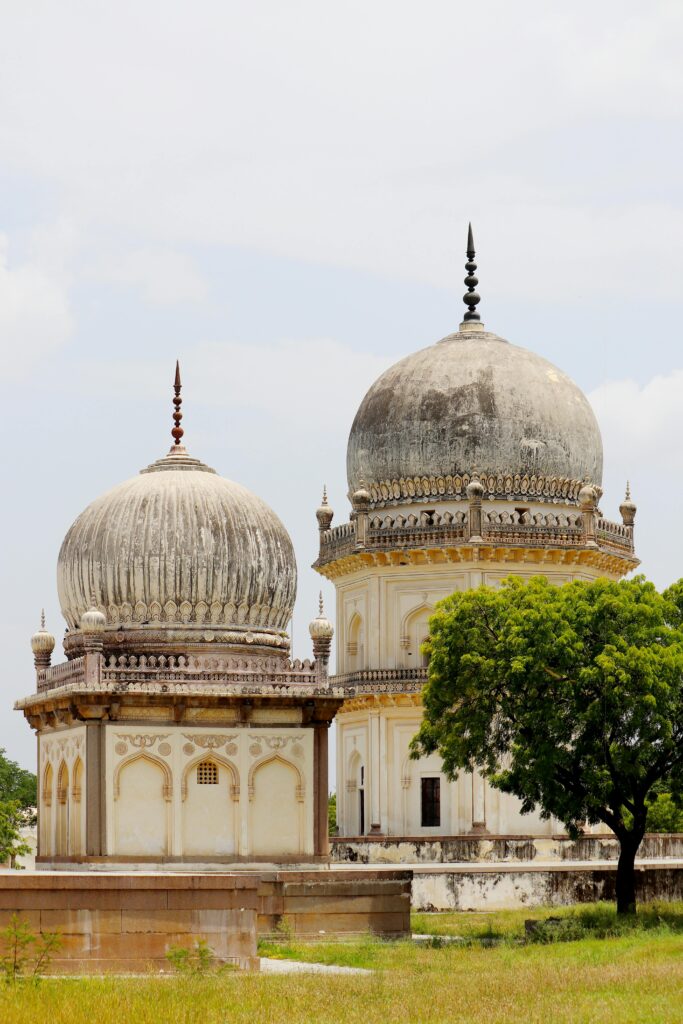 Stunning architectural shot of Qutb Shahi Tombs showcasing intricate domes and lush greenery in Hyderabad, India.